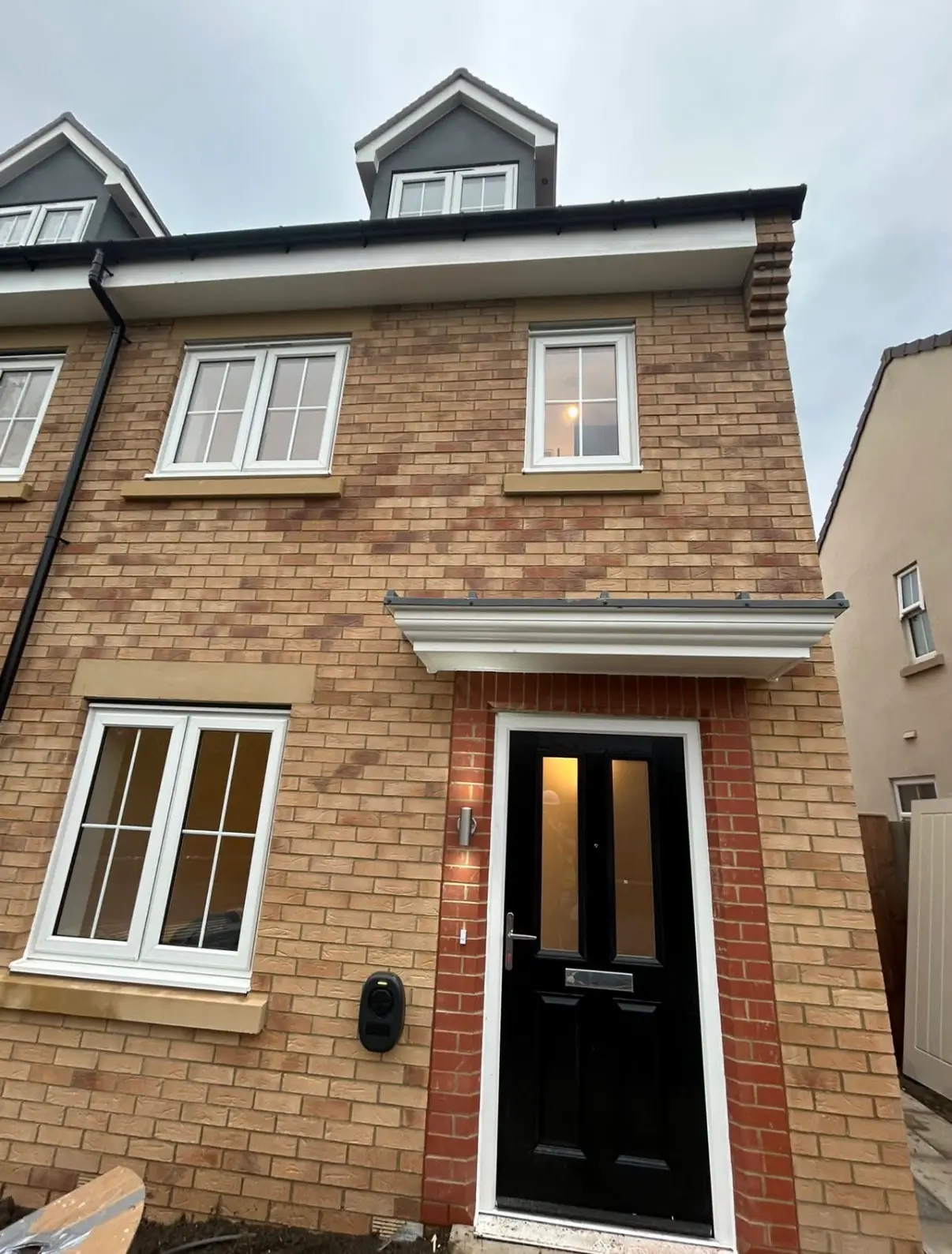 New-build brick building with fitted windows and door frames
