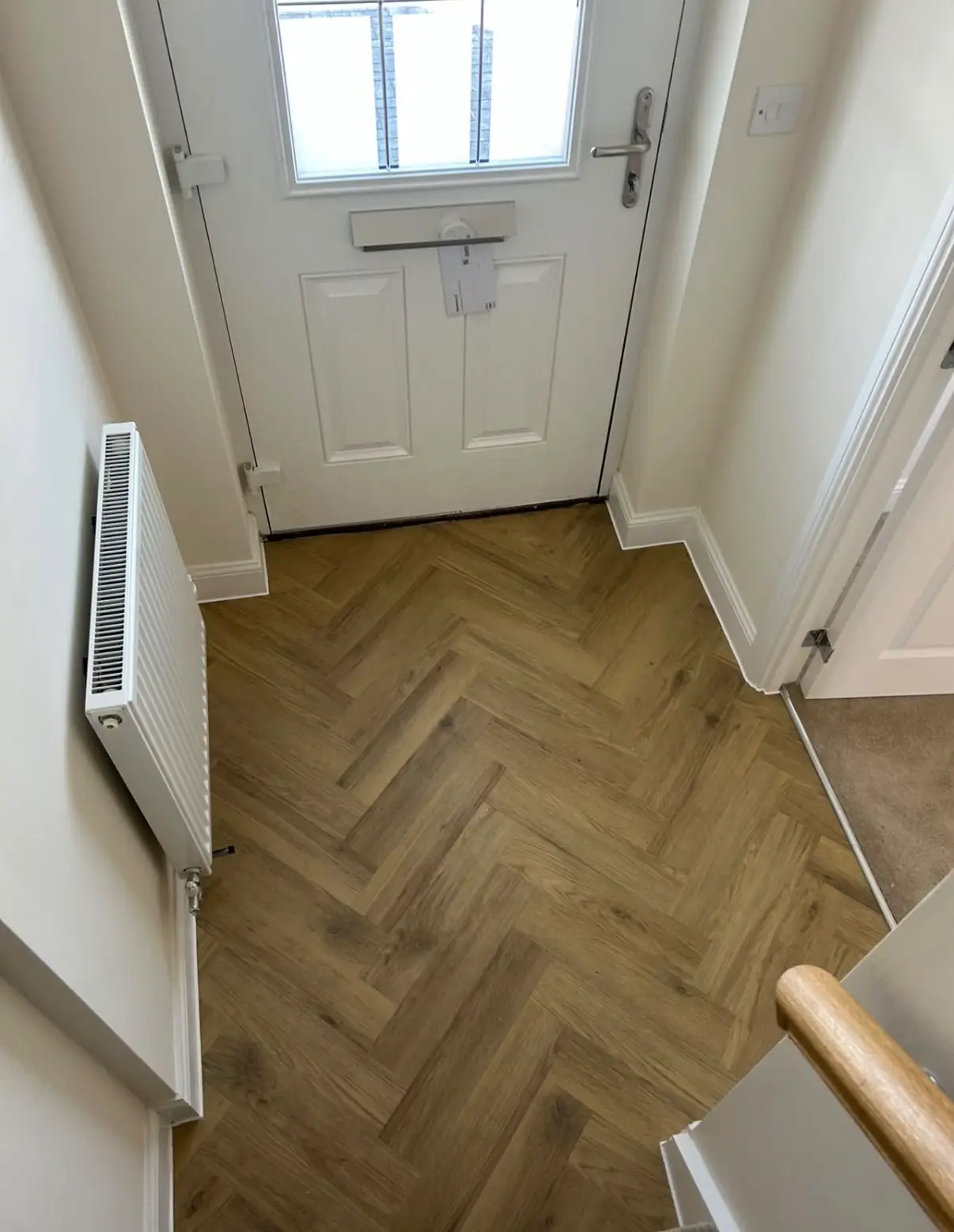 Hallway floor meeting skirting and a door threshold